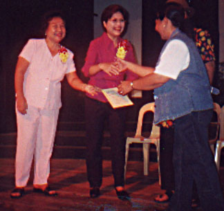 Regina G. de Jesus (center), WFMH Regional Vice President for Southeast Asia, receives a Certificate of Appreciation as the Guest of Honor during World Mental Health Day celebration in Bacolod City on 10 October 2001