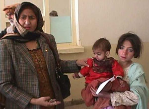 Dr. Unaiza Niaz with two sick refugee children.